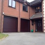 A Pair of Timber Effect Automated Roller Doors